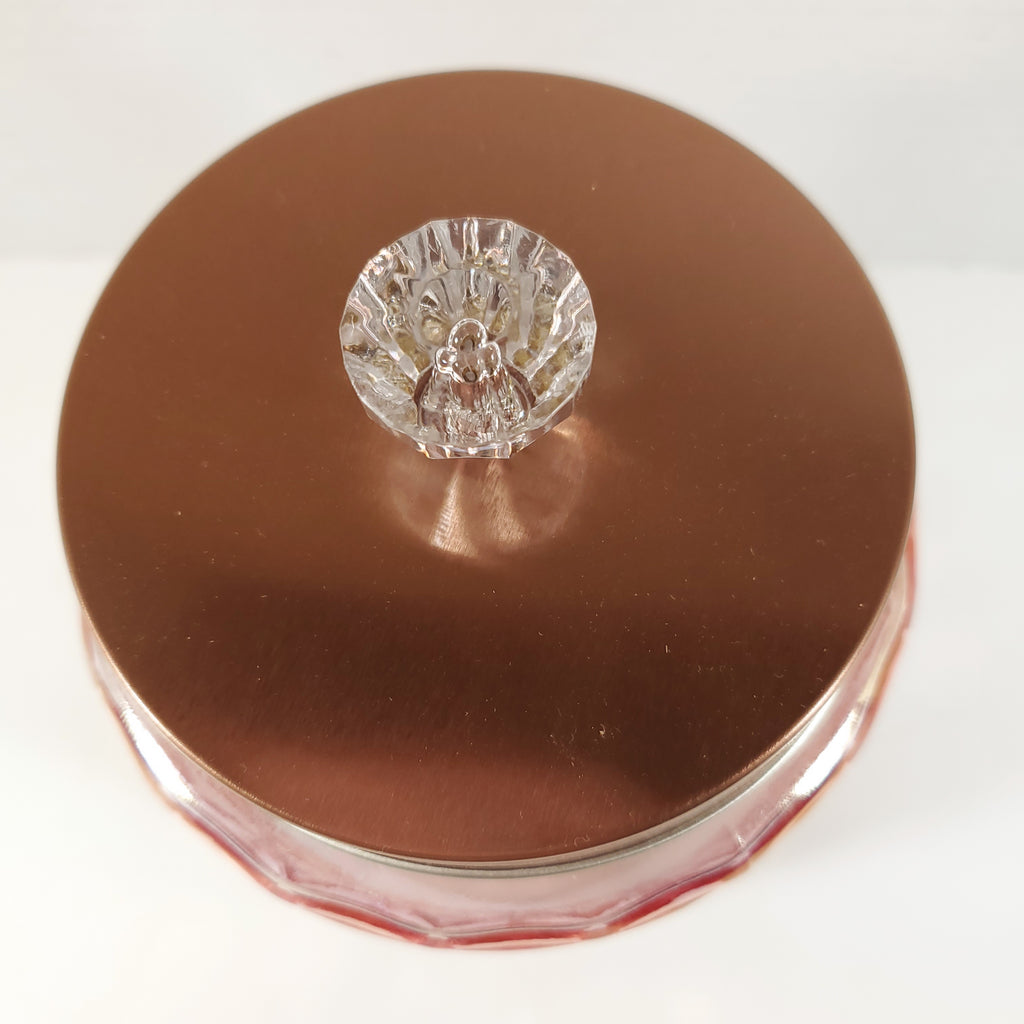 Blush pink textured glass storage jar with gold lid and crystal knob used for candy buffet and event table decor